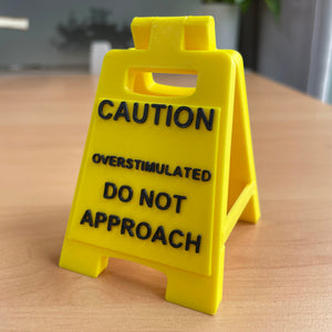 Caution Overstimulated Sign for Desk - Yellow Sign with Black Text, Warning Message for Safety Awareness