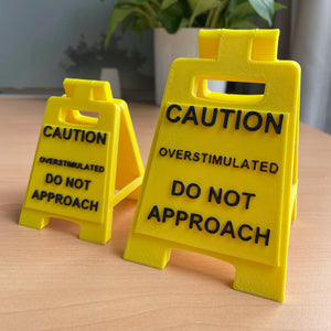 Caution Overstimulated Sign for Desk - Yellow Sign with Black Text, Warning Message for Safety Awareness